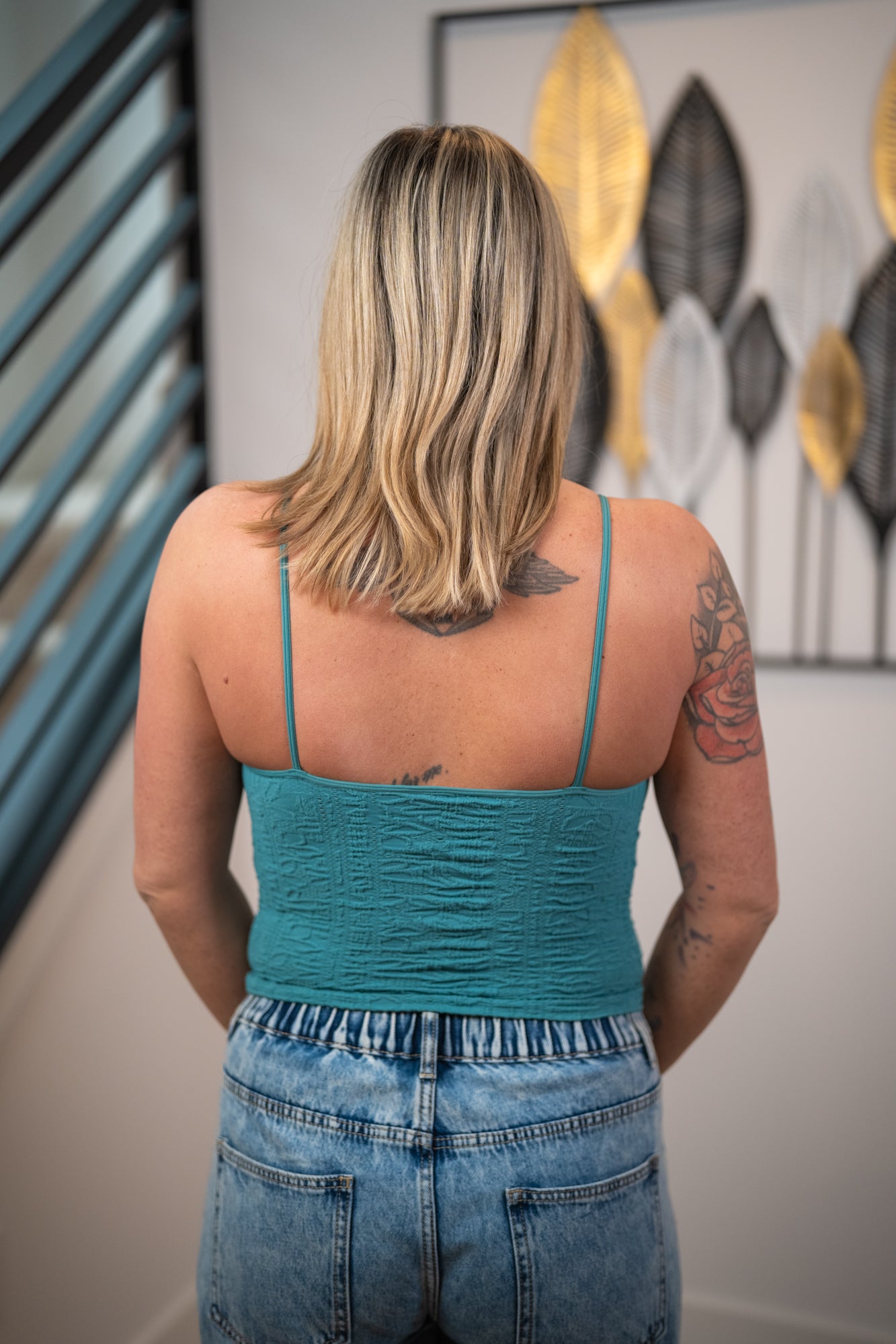 Back view of NikiBiki dusty teal seamless cami with spaghetti straps and stretchy fitted design