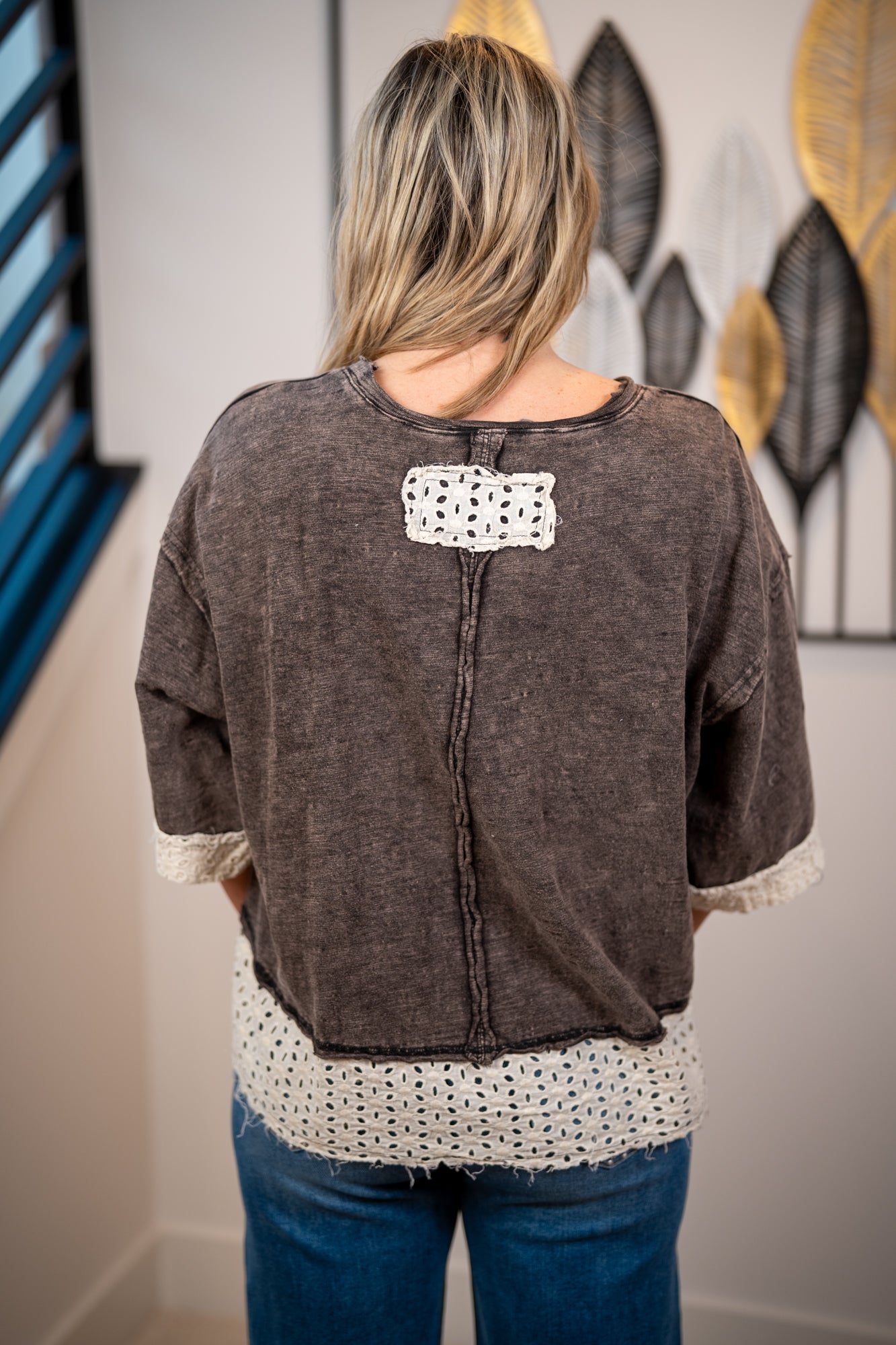 Back of mineral washed bow top featuring small lace detail, raw edge details, and lace trim details