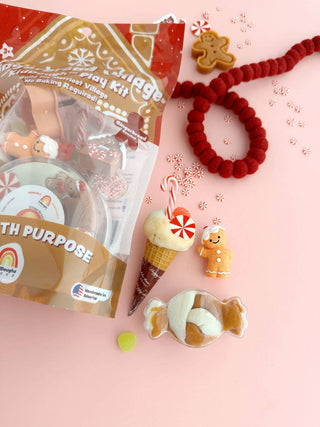 Gingerbread Village KidDough Play Kit bag with gingerbread figurines, candy cane, and red felt garland