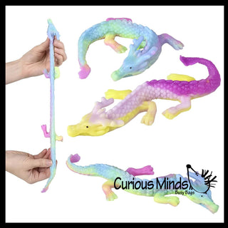 Colorful alligator toys with a hand holding one, on a white background with 'Curious Minds' branding.
