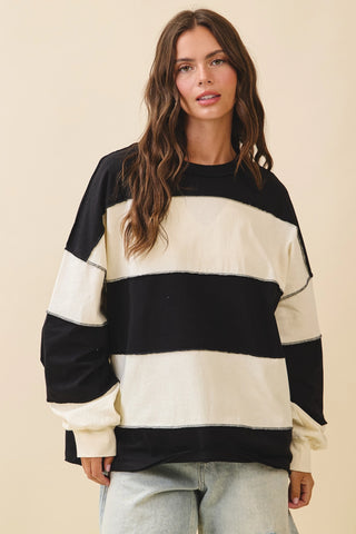 Oversized black and cream striped long sleeve pullover sweatshirt with contrast stitching