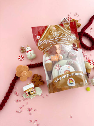 Gingerbread Village KidDough Play Kit bag with festive holiday accessories on pink background