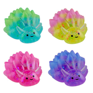 Four glittery squishy axolotl toys in teal, yellow, pink, and purple colorways