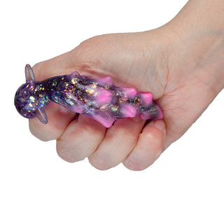 Hand squeezing purple glitter silicone sea slug sensory toy with pink spots