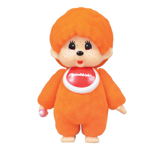 Orange Monchhichi doll with fluffy hair and red bib on white background