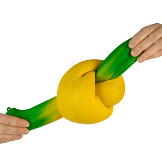 Two hands holding a yellow and green stress ball against a white background
