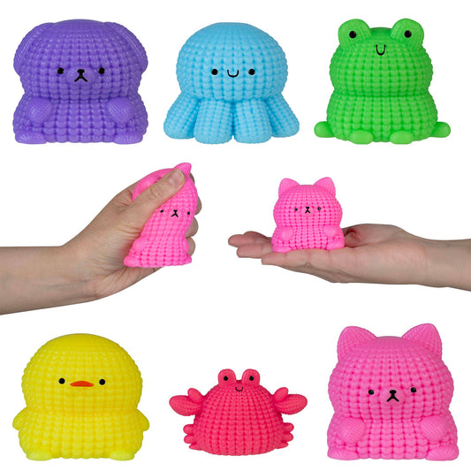 Colorful textured toys including a purple octopus, blue octopus, green frog, pink cat, yellow duck, pink crab, and pink bear held by hands on a white background.
