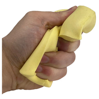Hand squishing a yellow butter slime stick, showing stretchy malleable texture