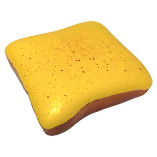Yellow cheese toast shaped slow-rise squishy toy with red speckled surface
