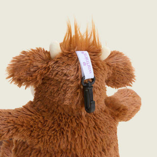 Warmies Highland Cow plush bag charm with black clip and branded ribbon tag