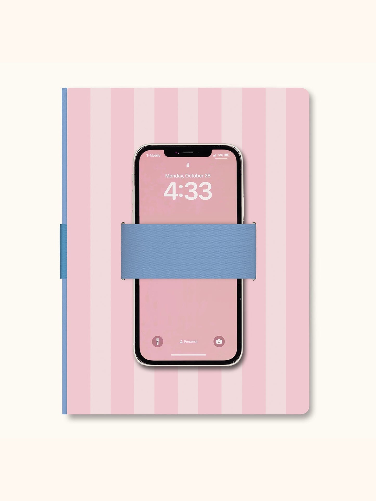 Pink striped notebook with blue elastic phone holder loop and smartphone inserted