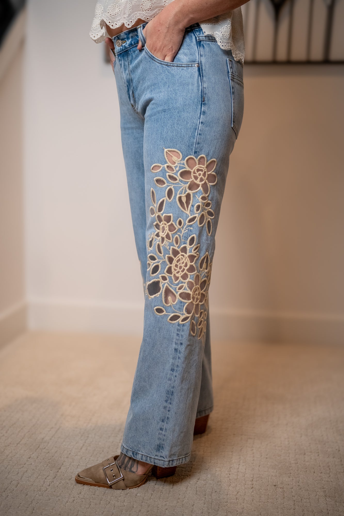 close up detail of the lace cut out on the straight leg denim