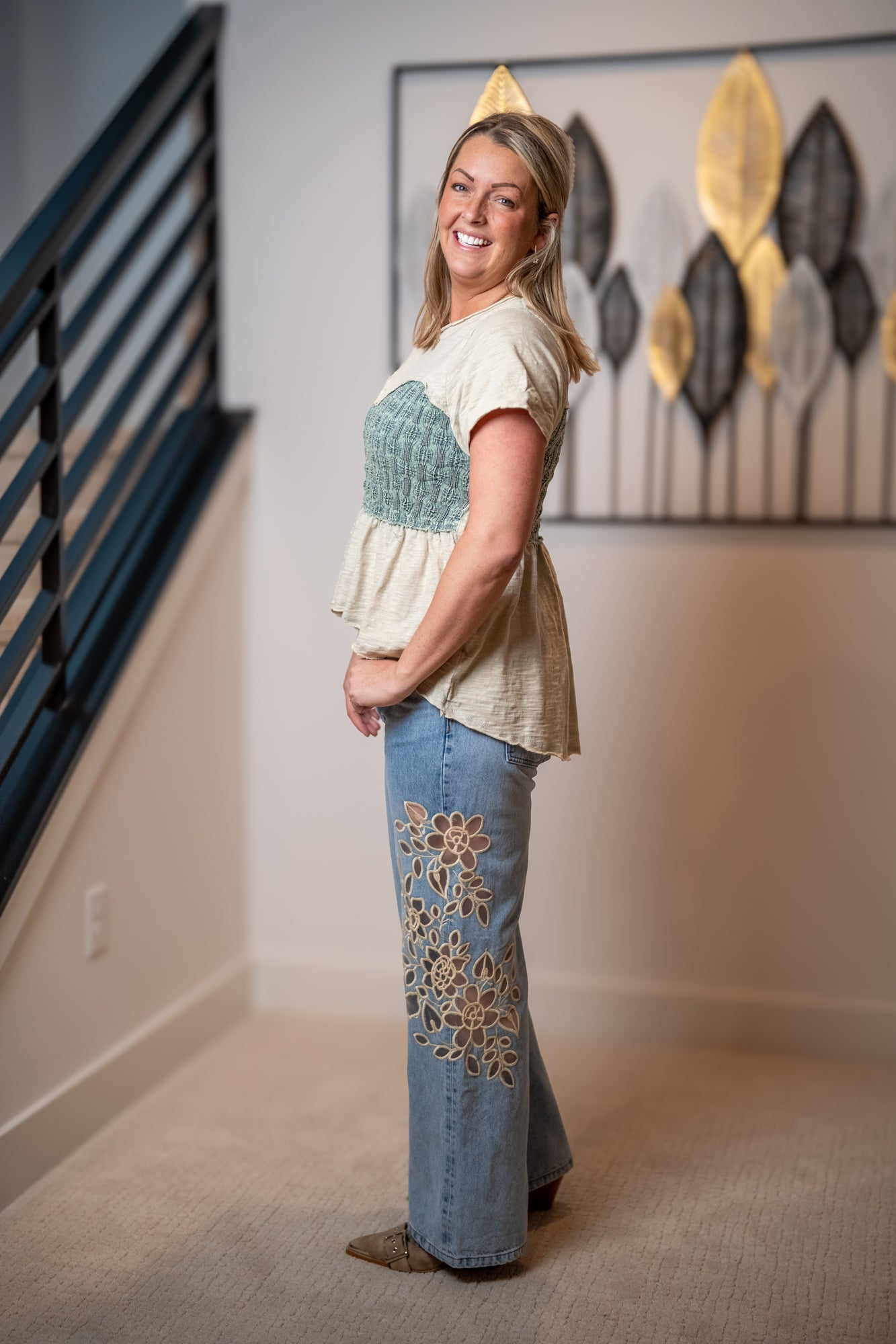 Side view of Oli and Hali sage smocked peplum top with textured bodice and flared hem