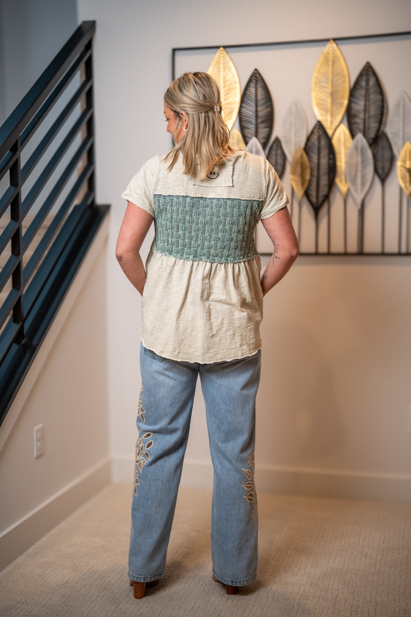 Back view of Oli and Hali sage washed peplum top with smocked detail and relaxed silhouette