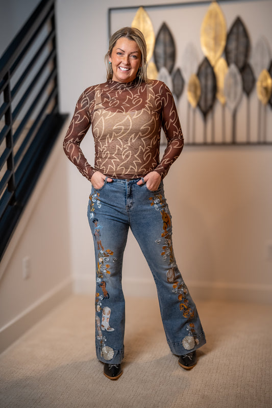 Woman wearing a sheer brown top with western details Blue B layering top