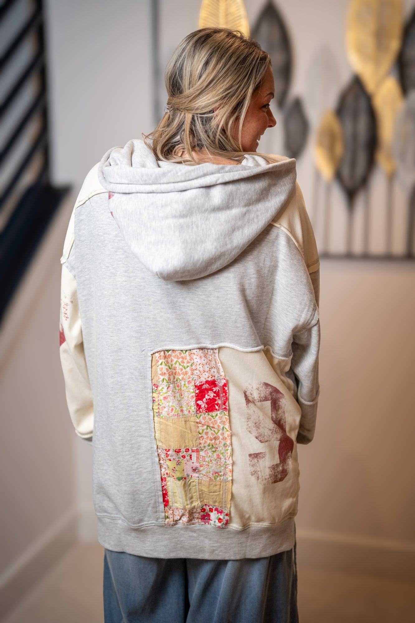 Back view of Oli and Hali patchwork hoodie with mixed fabric panels and oversized fit