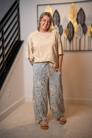 Model wearing Easel striped embroidered wide leg pants with drawstring waist and relaxed fit