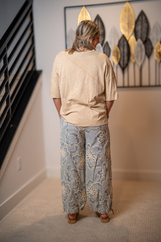 Back view of Easel striped embroidered wide leg pants with elastic waistband and flowy fit