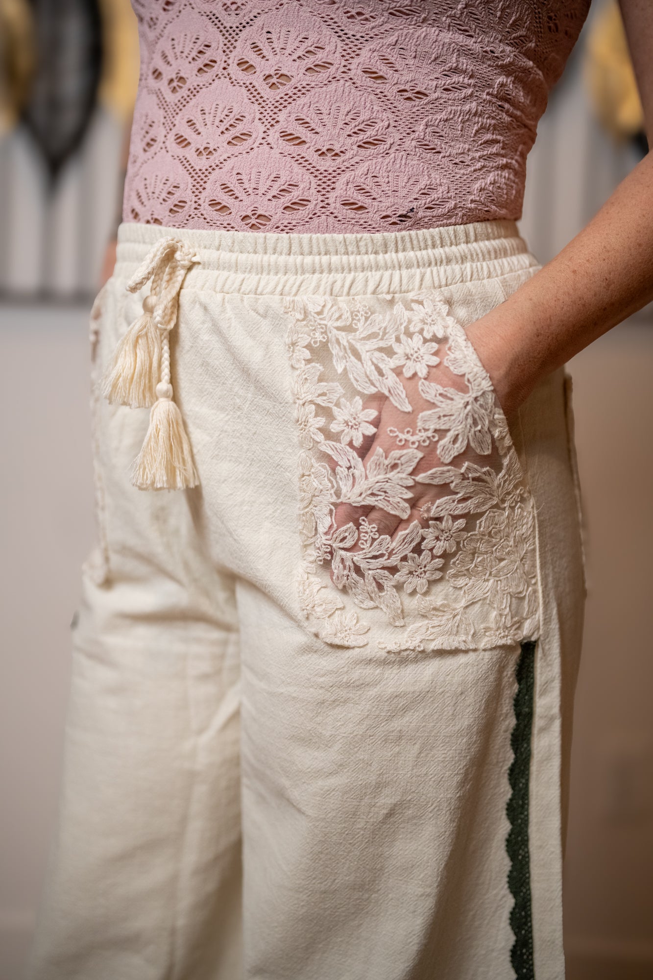 Lace-trimmed pants with a matching lace top, blurred background