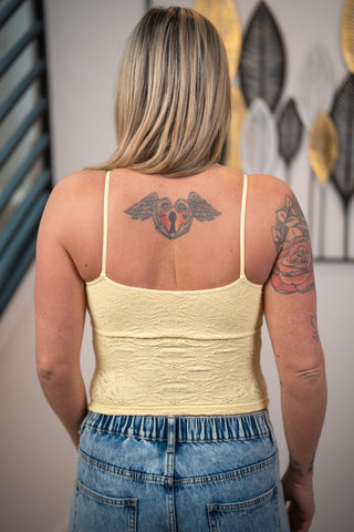 Back view of NikiBiki pale banana seamless lace cami with fitted stretchy silhouette