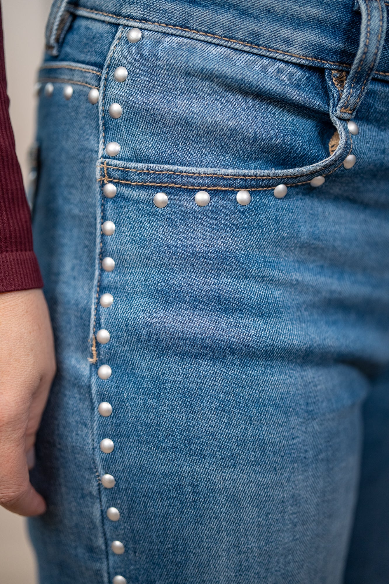 Close up detail of the studded detailing on the seams and around pockets