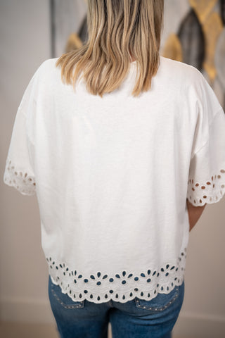 Back view of Easel white eyelet hem top with scalloped embroidery detail and relaxed fit