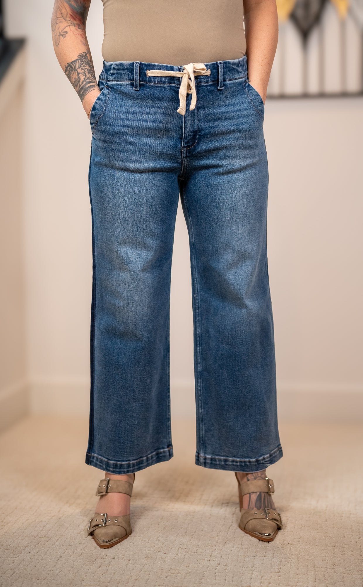 Close up of Risen elastic band high rise cropped wide leg jeans drawstring waist and denim wash detail