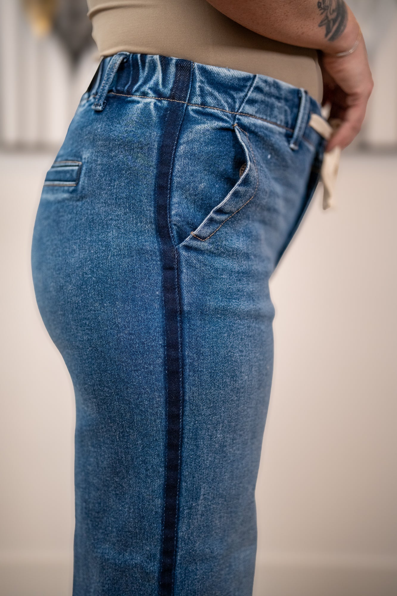 Close up side seam detail of Risen elastic band high rise cropped wide leg jeans