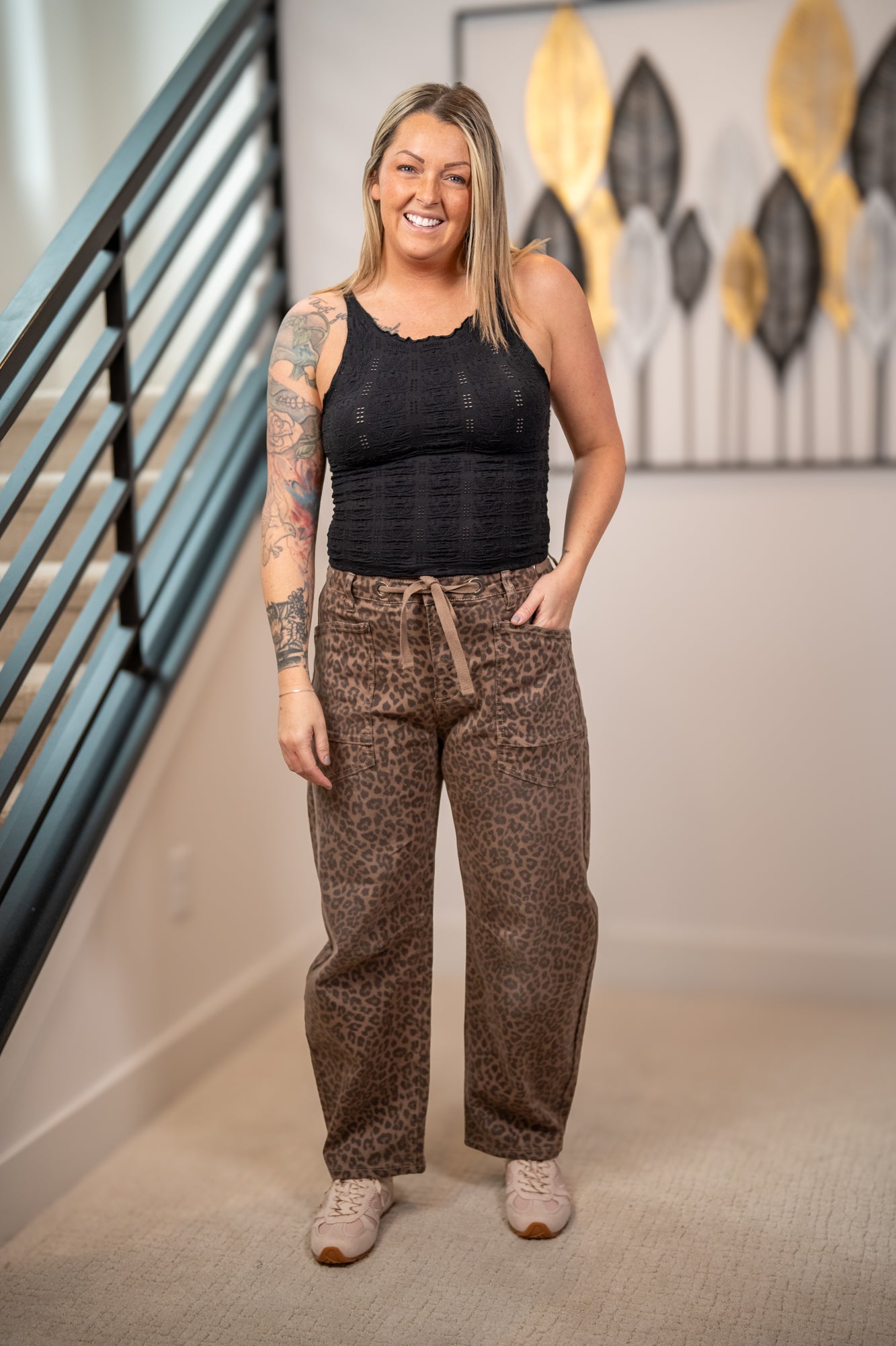Risen leopard print barrel fit pants with drawstring waist and cargo pockets styled with black textured tank