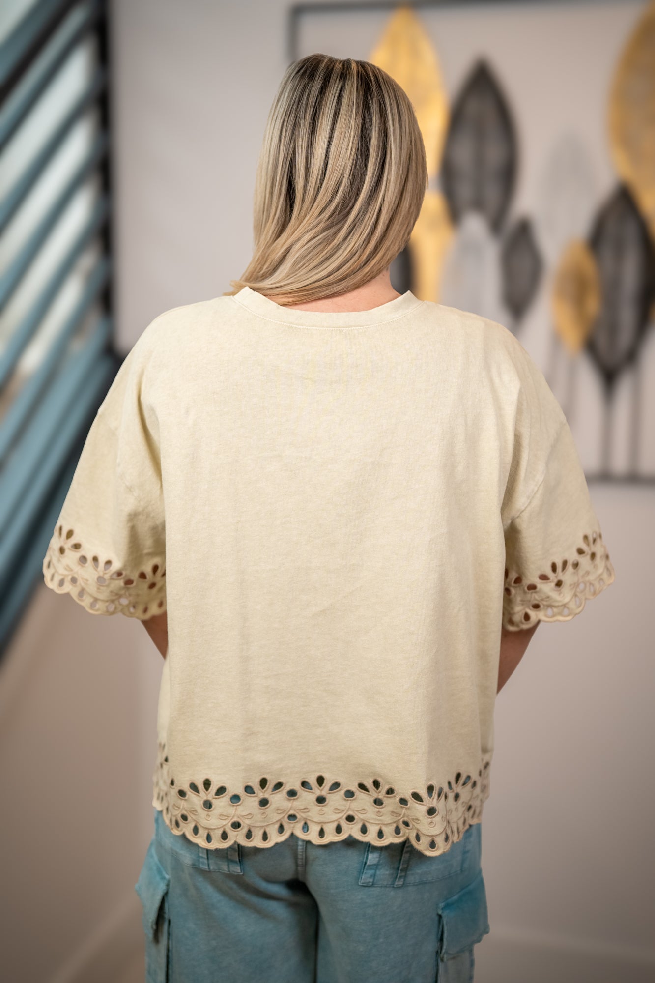 Back view of Easel khaki eyelet hem top with scalloped embroidery detail and relaxed fit