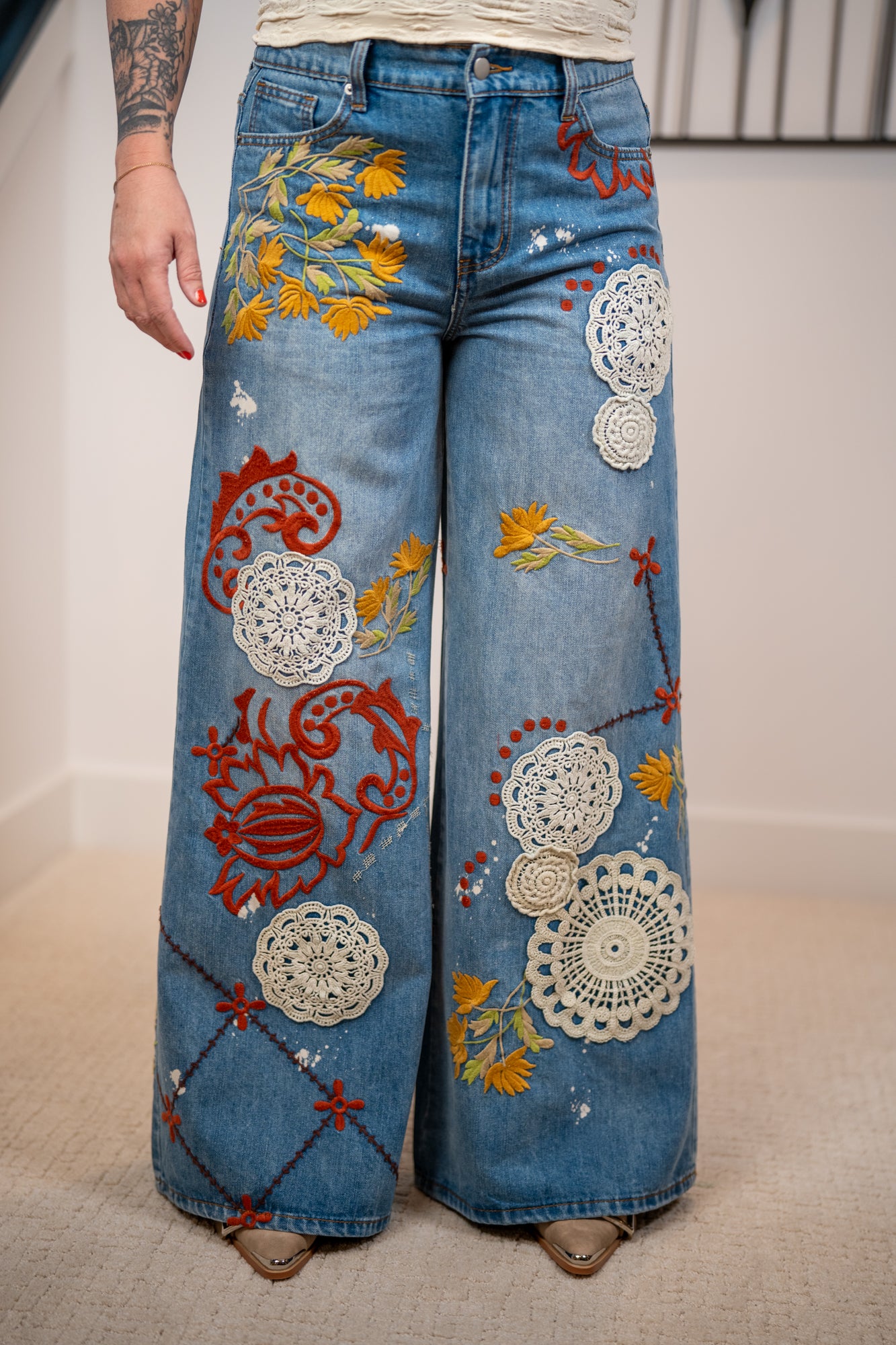 Effortless Bloom embroidered jeans by Oli and Hali with wide leg fit and colorful floral and crochet details