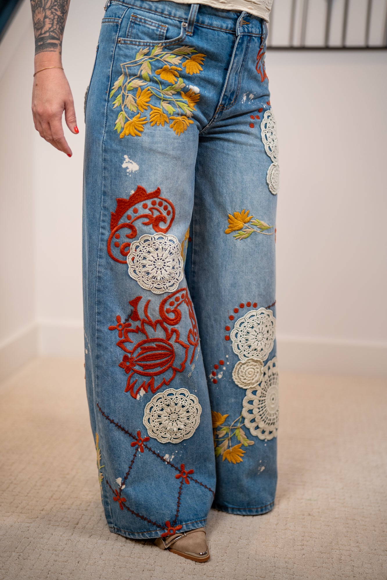 Oli and Hali statement wide leg jeans with intricate embroidery, floral designs, and vintage-inspired patchwork