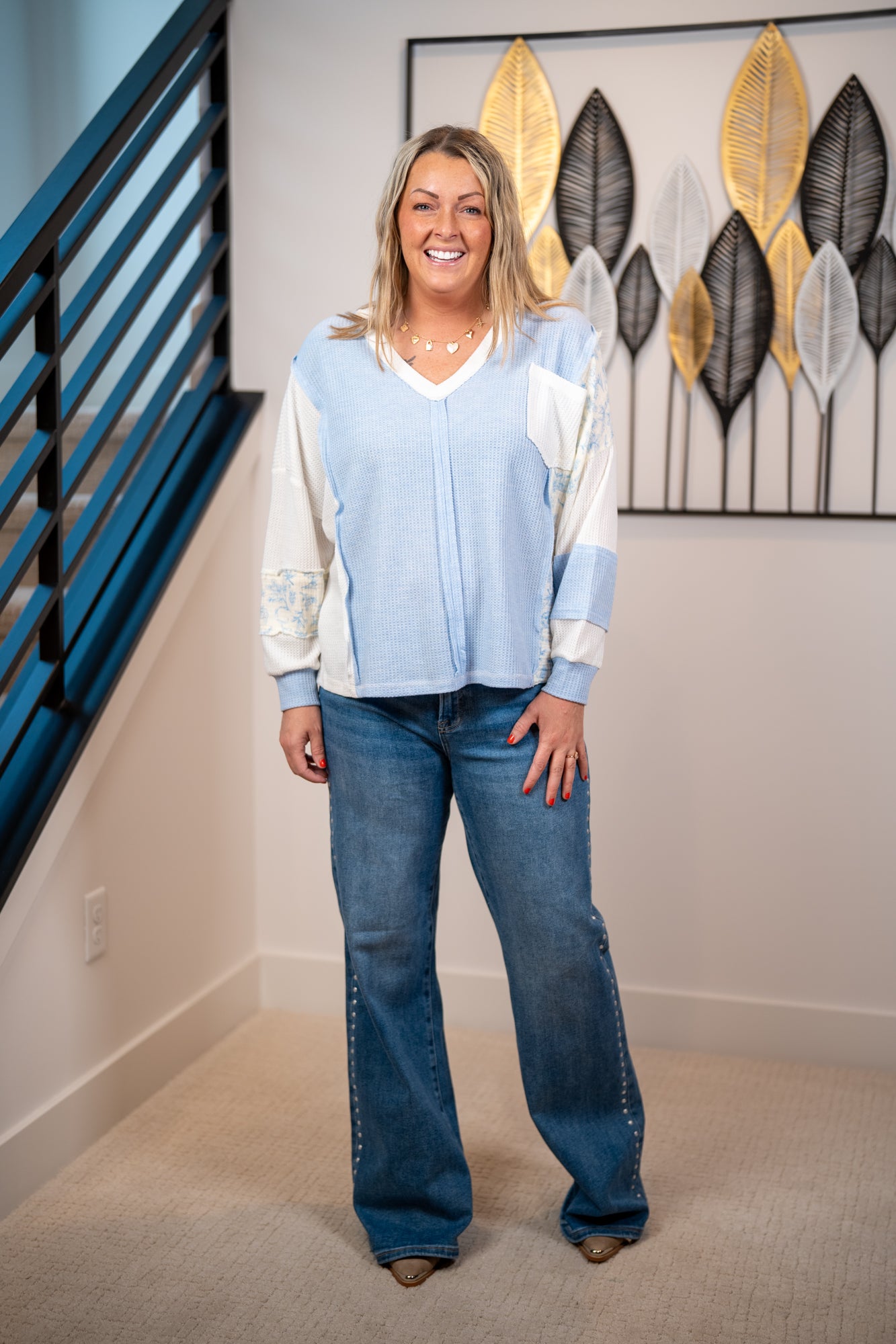 Patchwork floral sleeve waffle knit top with contrast panels and relaxed fit in soft blue paired with dark studded denim