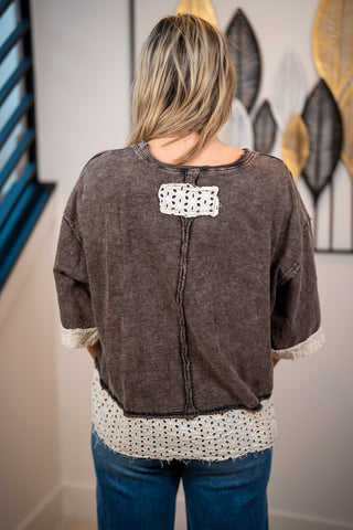 Back of mineral washed bow top featuring small lace detail, raw edge details, and lace trim details 