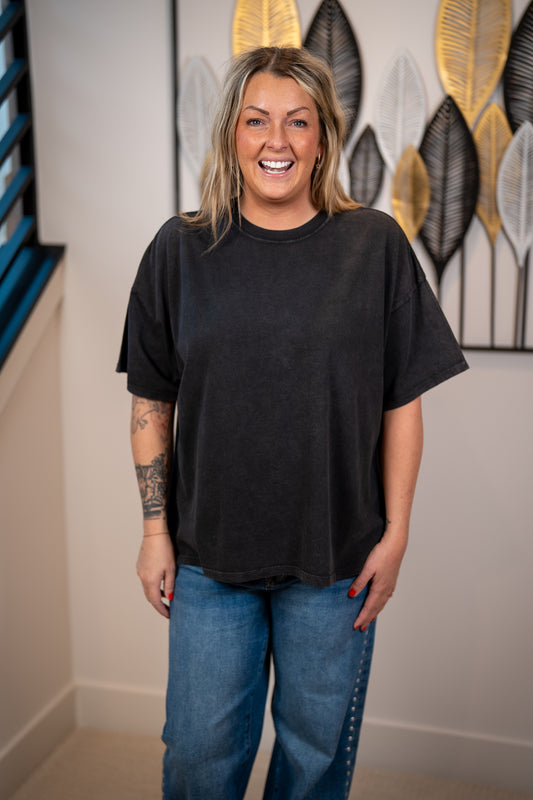woman wearing black boxy crew neck oversized tee with denim