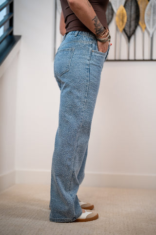 Side view of the rhinestone denim pants showing the back pockets