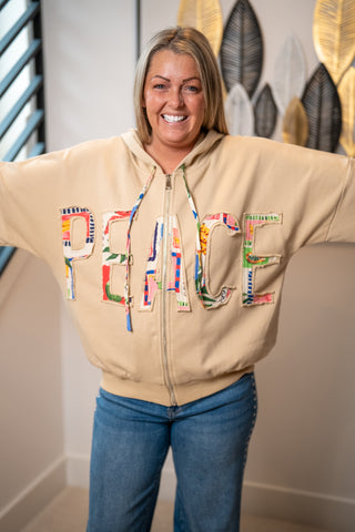 Beige zip-up hoodie with colorful patchwork PEACE letter appliqués across chest
