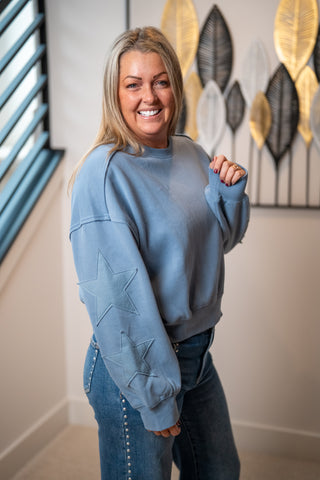 Blue star patch sleeve sweatshirt with embossed stars on arm, casual fit