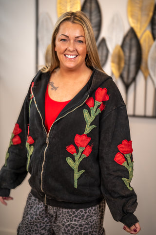 Black zip-up hoodie with red rose embroidery and ribbed cuffs