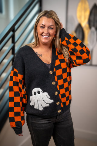 Black and orange checkerboard Halloween cardigan with ghost appliqué and gold buttons