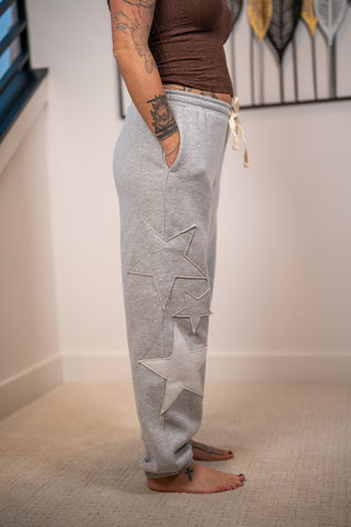 Gray heather jogger sweatpants with three tonal star patches and cream drawstring