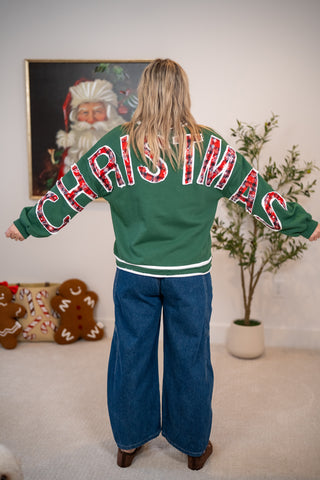 Green sweatshirt with red plaid CHRISTMAS lettering across back and sleeves
