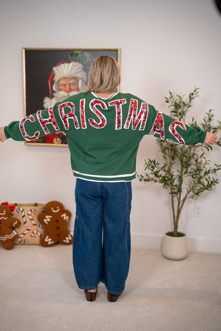 Green sweatshirt with red plaid CHRISTMAS lettering across back and sleeves
