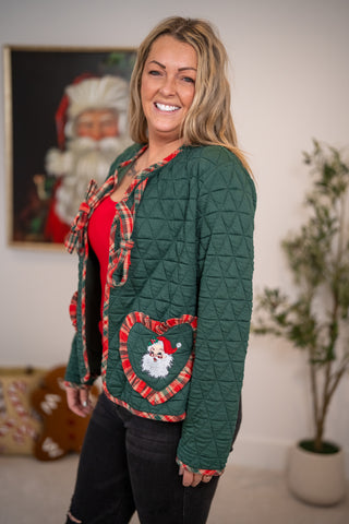 Green quilted Santa jacket with plaid trim, bow closure, and heart-shaped Santa pocket