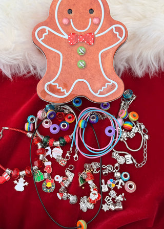 Gingerbread man-shaped jewelry holder with colorful beads and charms on a red background