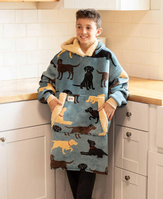 Child wearing Lazyone Labs Blanket Hoodie featuring Labrador dog pattern in kitchen setting