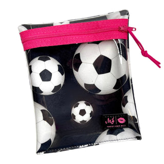 Clear pouch with pink zipper containing soccer ball designs on a white background