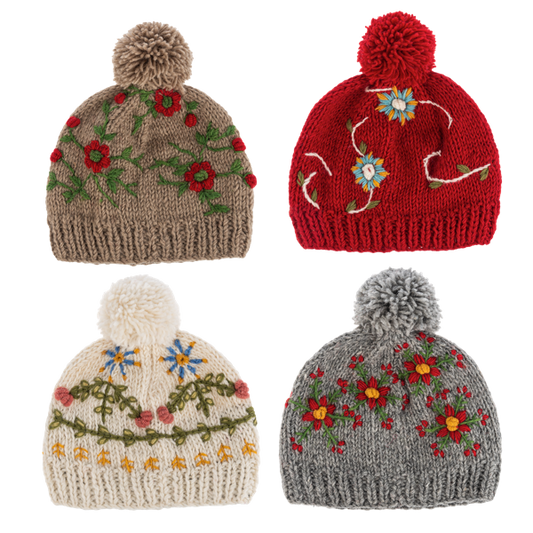 ganz Four knitted hats with floral patterns and pom-poms on a white background