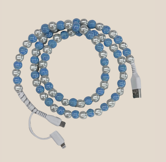 Blue and pearl beaded USB charging cable with multiple connectors on beige background