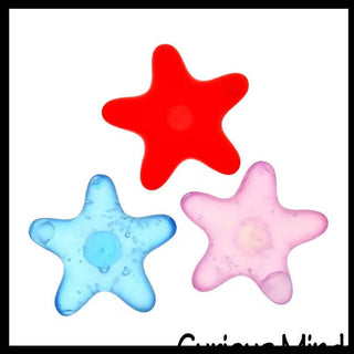 Three star-shaped objects in red, blue, and pink on a white background.